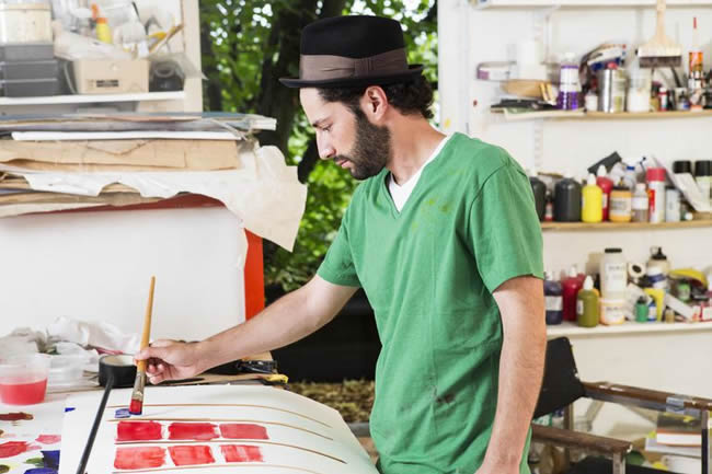 Artist working on a painting in art studio