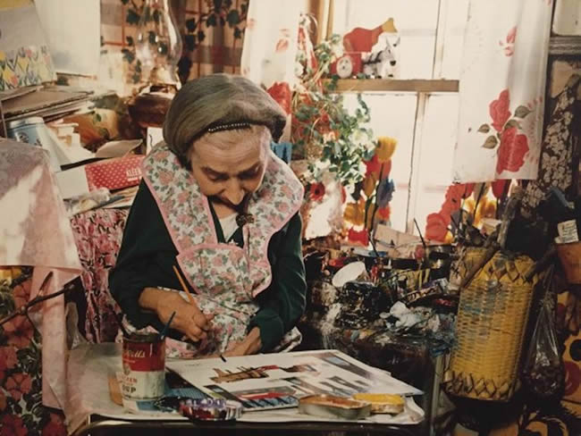 Maud Lewis painting in her home in Nova Scotia