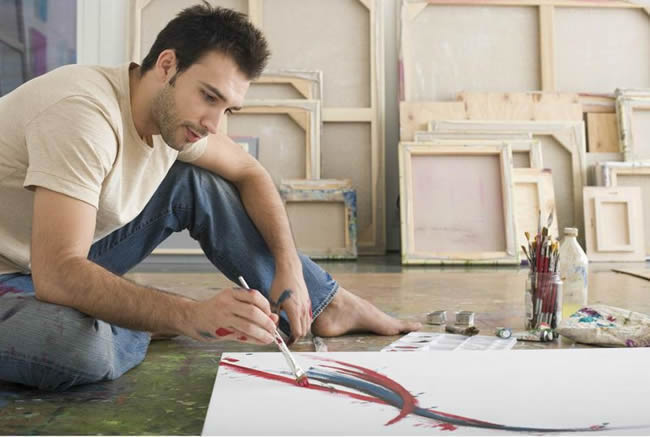 Artist Working on Canvas on Floor of Studio