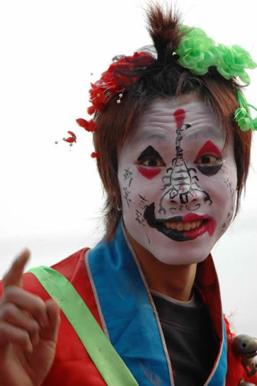 Face Painting Designs -- Man on Stilts, Photographed in China