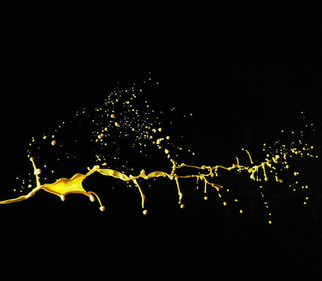 Yellow color splash on black paint canvas