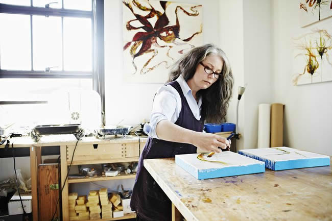 Female painter working on painting in studio