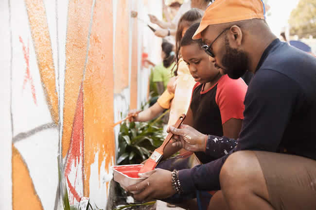 People painting wall together