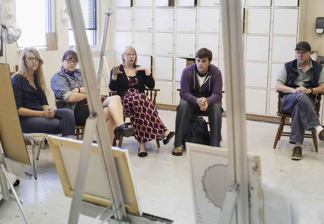 Artists critiquing work in studio