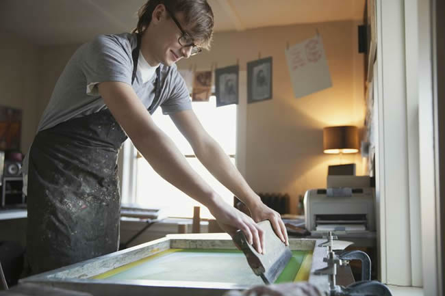 Artist working on silk screen