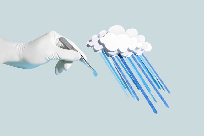 Hand holding a drop of paper craft rain from cloud