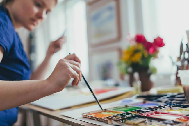 Woman painting watercolour.