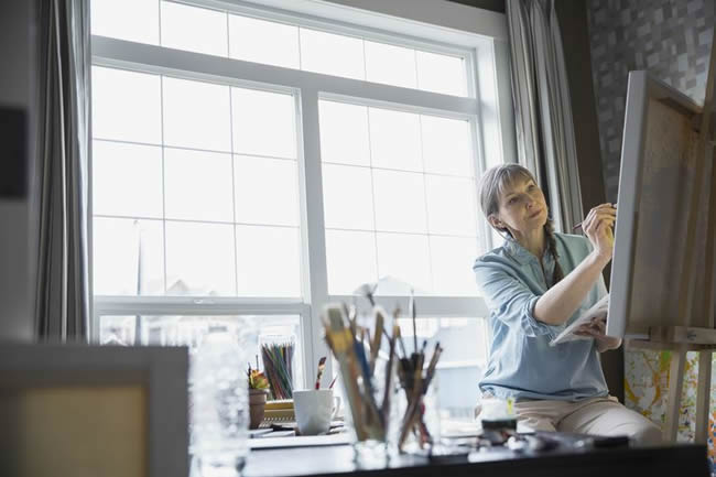 Woman painting in apartment