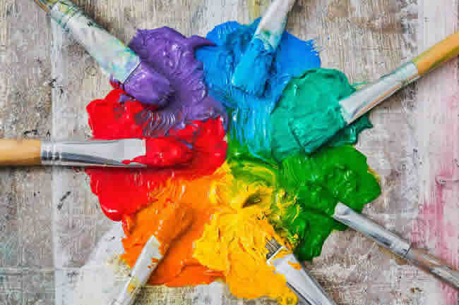 Brushes and oil paint, messy spectrum of colours
