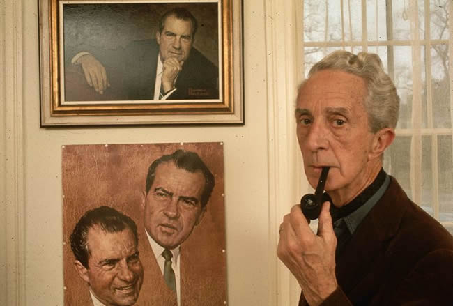 Norman Rockwell in front of his work