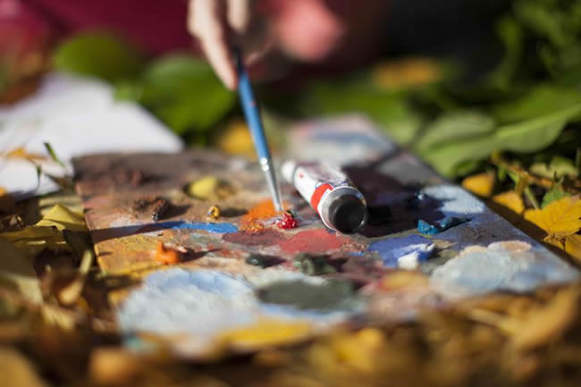 Person painting outdoors