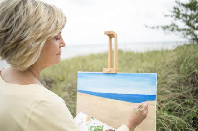 Painter painting a landscape with obvious horizon line
