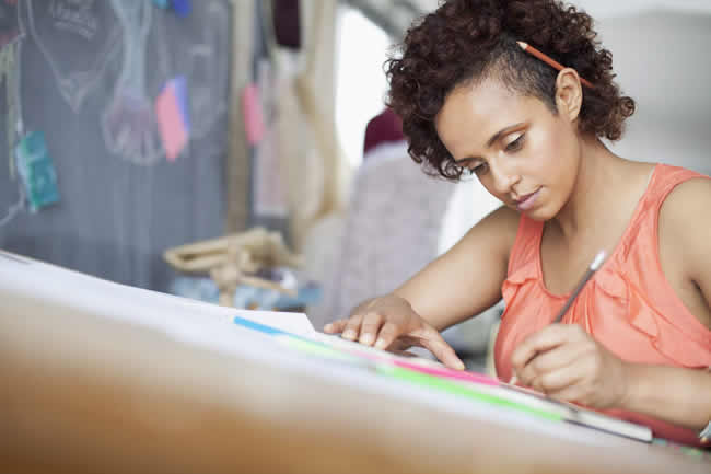 clothing designer sketching ideas in studio