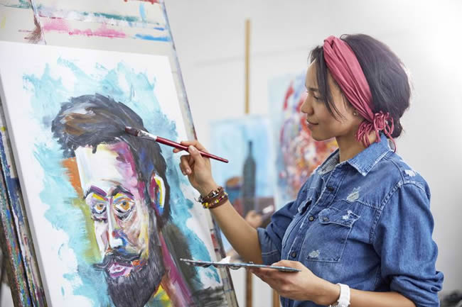 Female artist painting in art studio