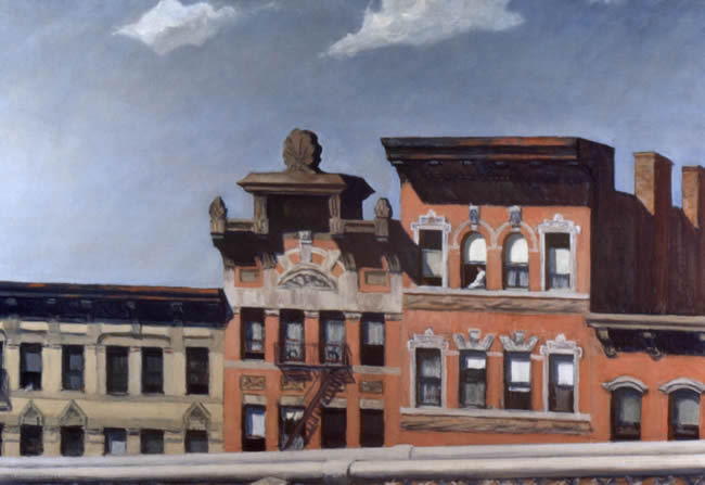 Red brick city buildings against a blue sky