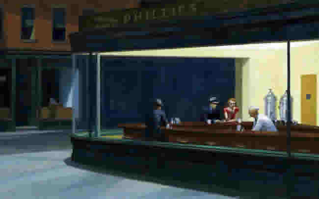 On an empty street, views through a lighted window show four people in a diner.