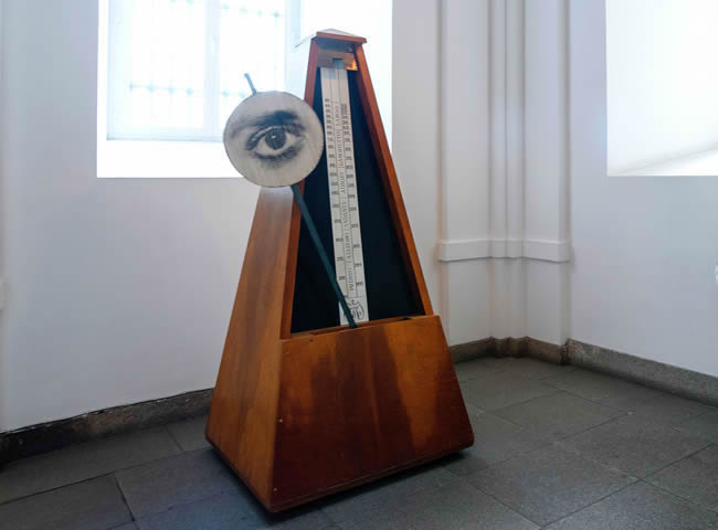 Metronome with a drawing of an eye attached