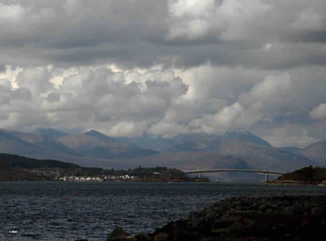Bridge to the Isle of Skye under a cloudy sky.