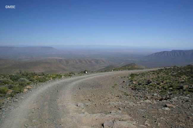 Mountain road under a deep blue sky.
