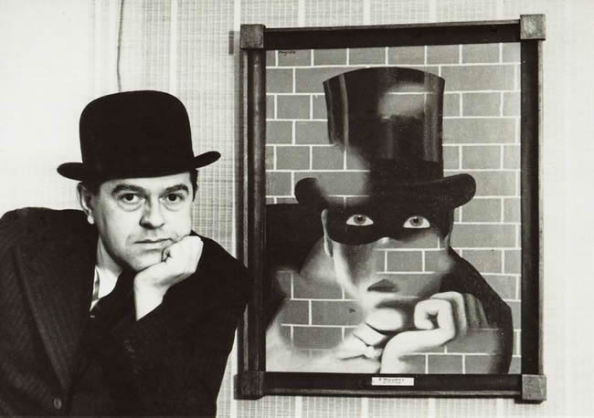 René Magritte posing in front of painting Le Barbare