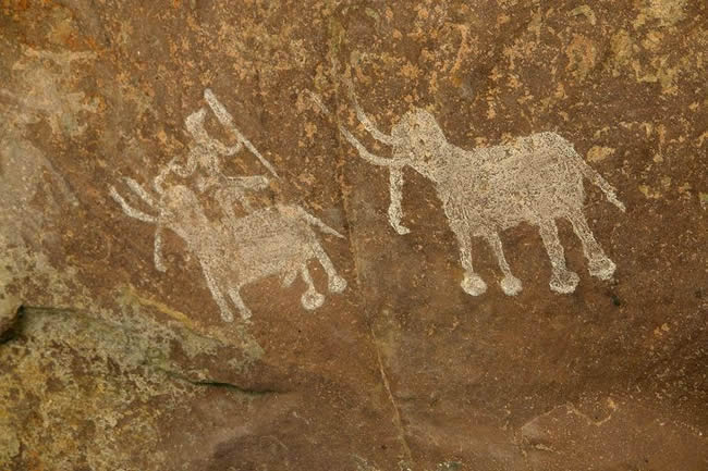 mesolithic artwork depicting elephants and a rider