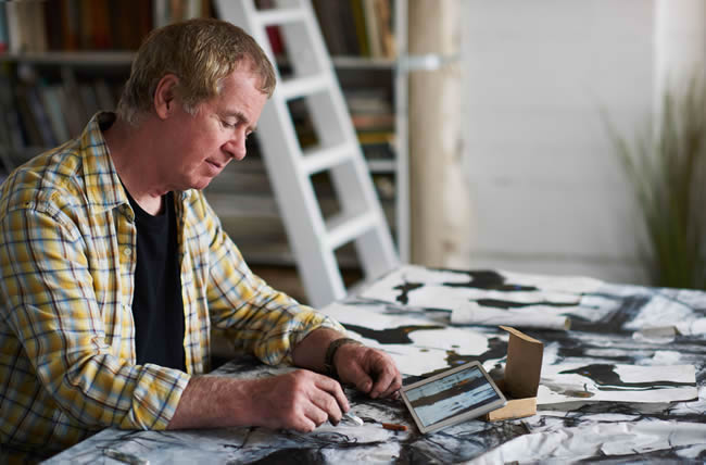 Artist working from reference on a digital tablet