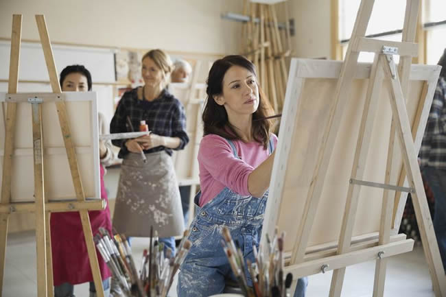woman painting on canvas