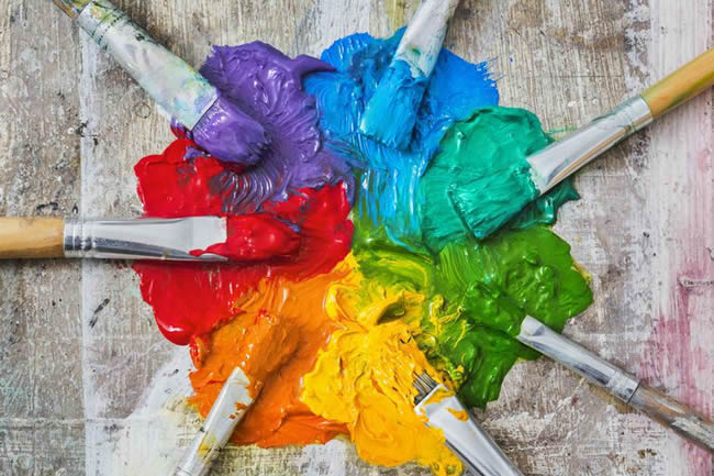 Brushes and oil paint, messy spectrum of colours