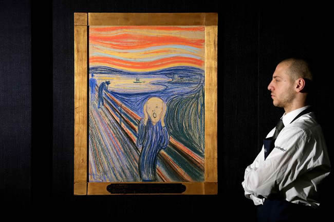 A gallery technician looking at the painting 