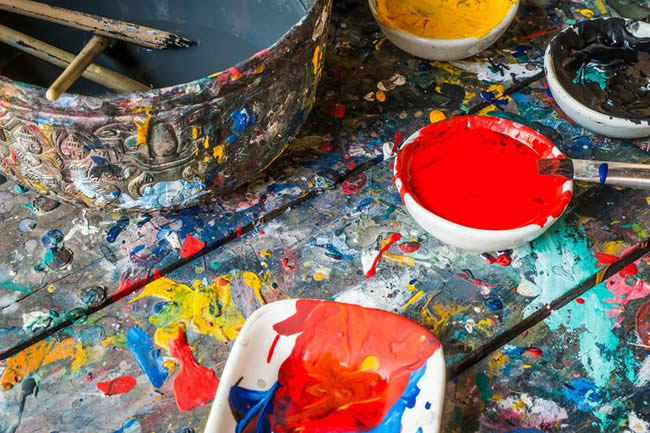 Oil paint on a workbench.
