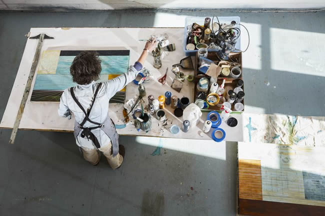 Overhead view of artist working on a painting