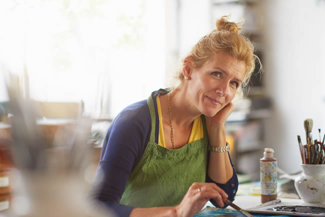 Portrait of mature female designer in her studio