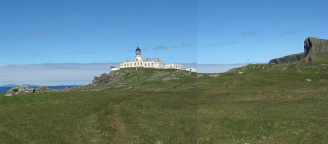 Neist Point Lighthouse, Isle of Skye, landscape photograph taken on a sunny day with a blue sky.