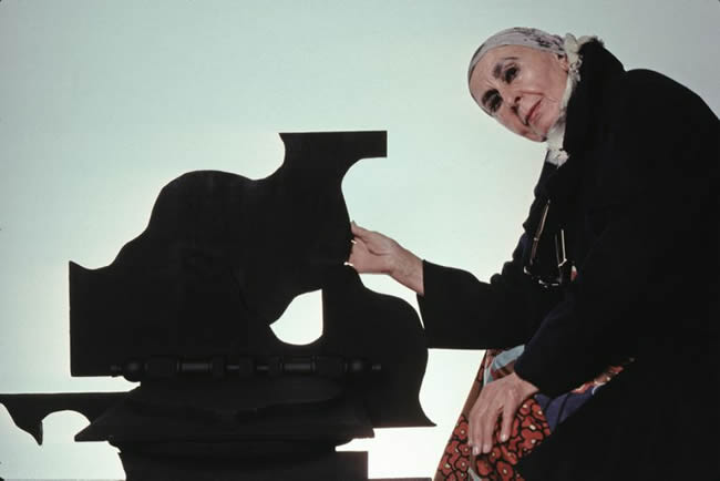 Sculptor Louise Nevelson with her work
