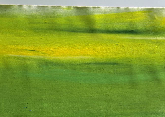 Yellow and green paint on fabric, full frame